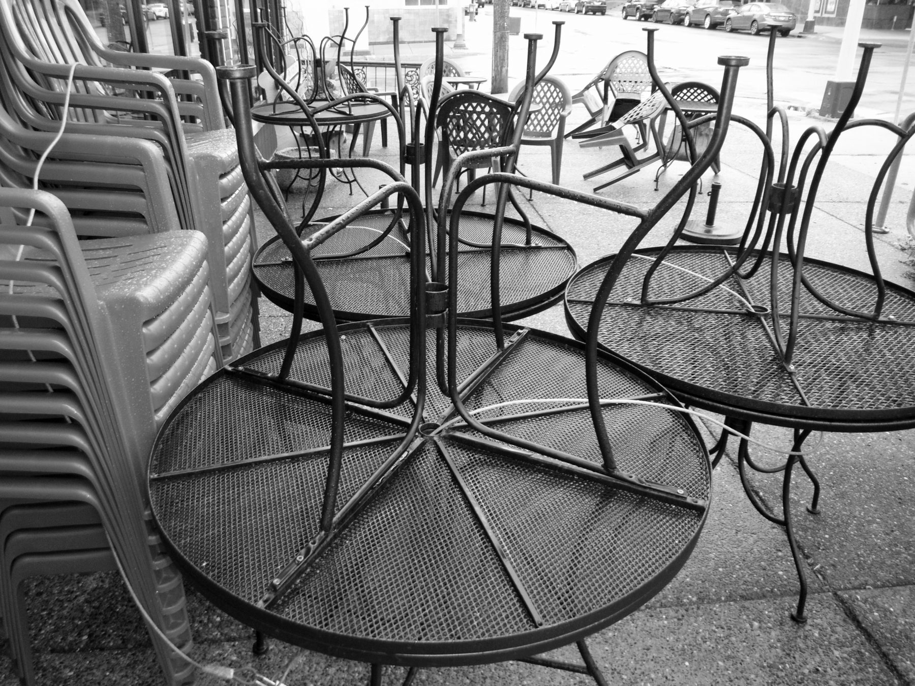 chairs_and_tables_tilted_up_in_rain_riverview_cafe_mpls_mn_19_bw_b15