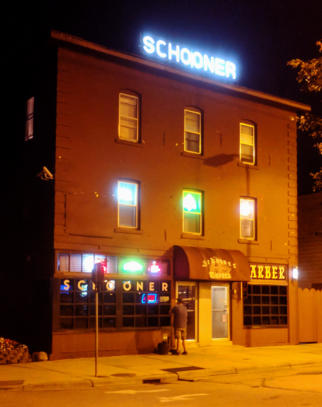 Schooner Tavern with sign lit at night