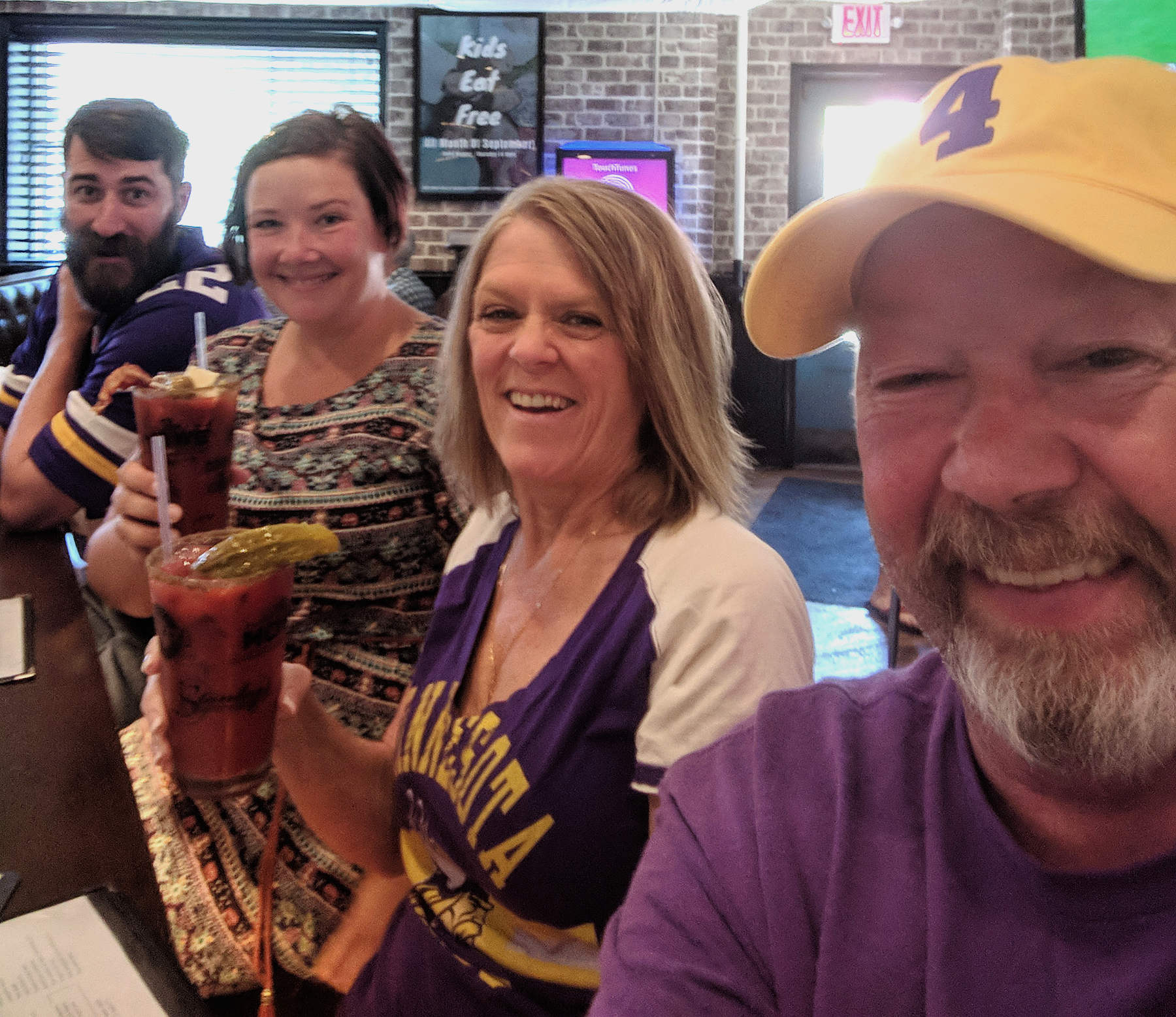 Group of four at bar with some Vikings jerseys