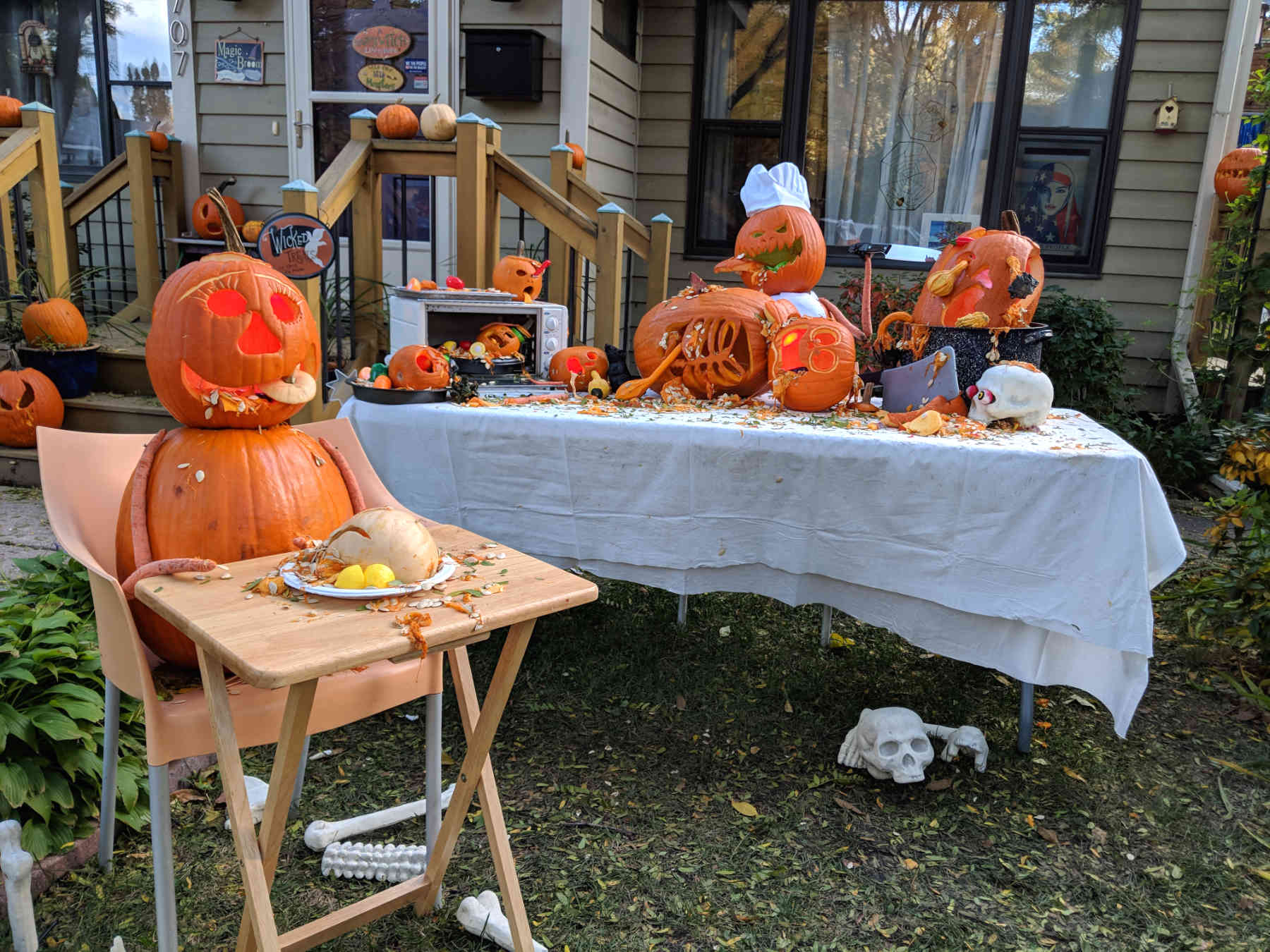 Carved pumpkin display with pumpkins eating pumpkins