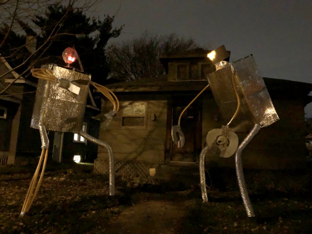 silvery robots in dark yard