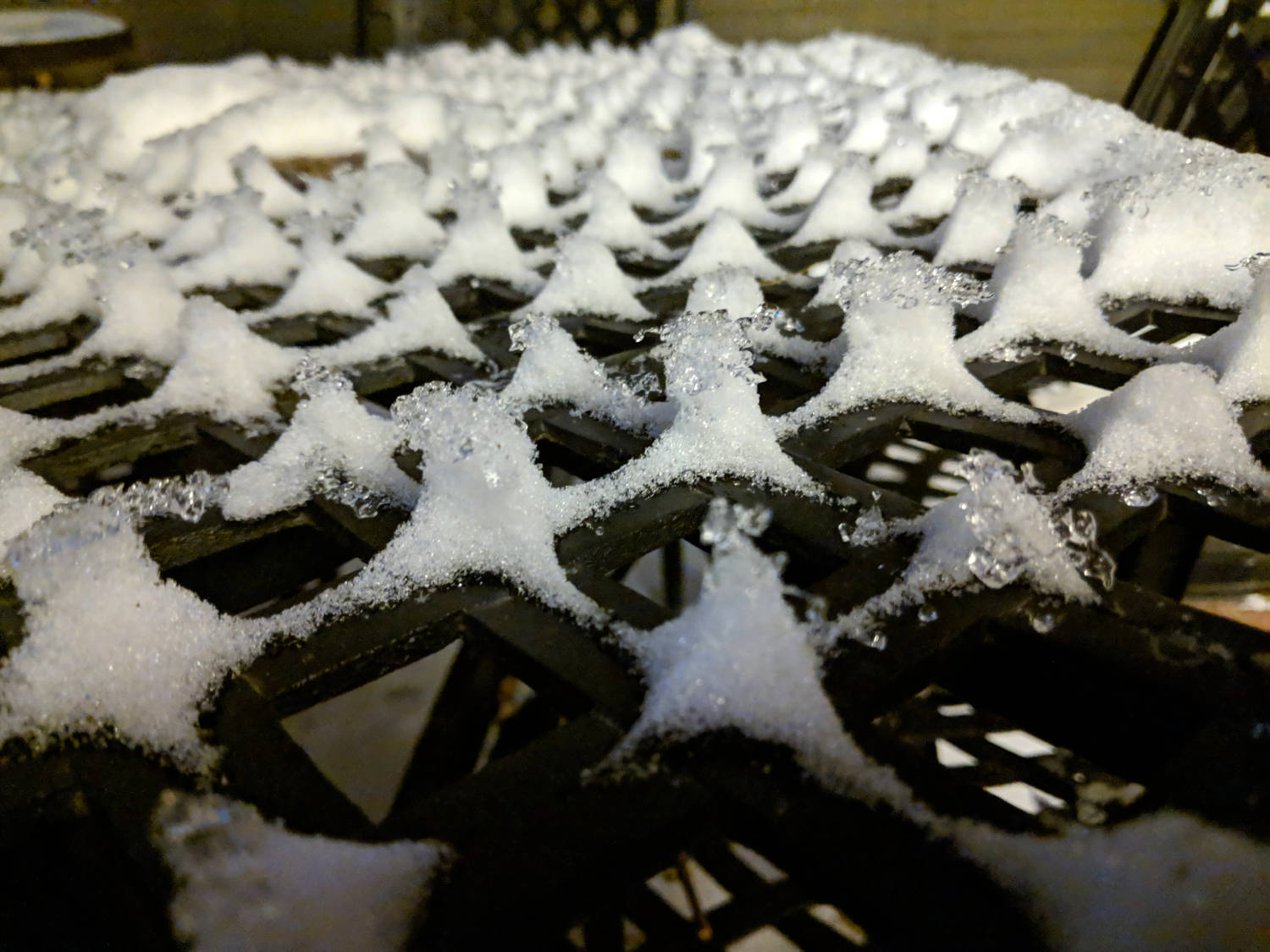 little towers of ice on a metal grate