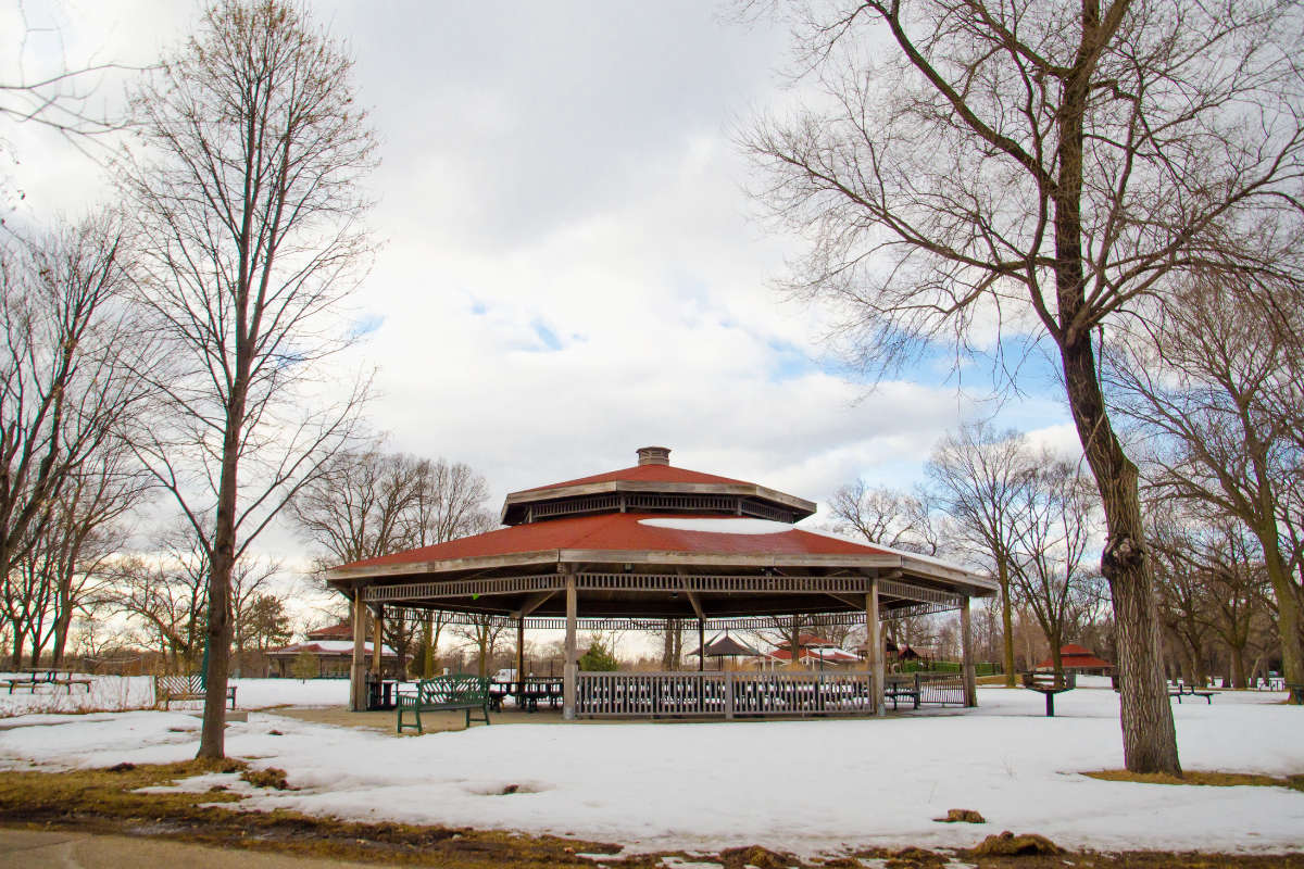 Large park pavilion with red roofs in the winter
