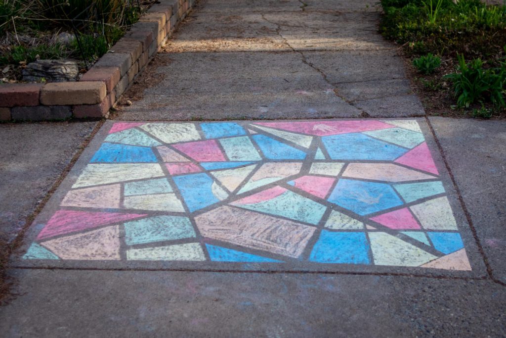Colorful pattern, like stained glass, with chalk on a sidewalk