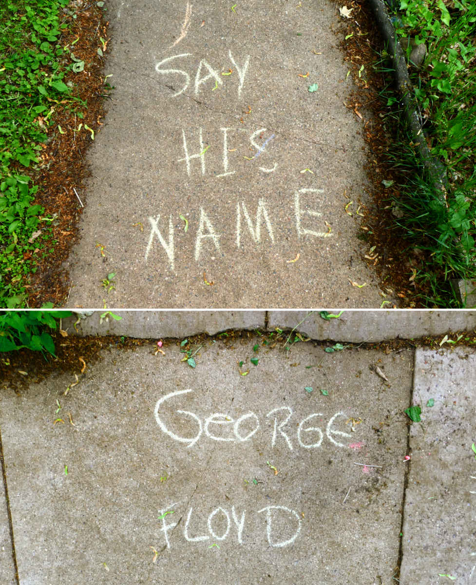 Chalked letters on two sidewalk segments: Say His Name & George Floyd