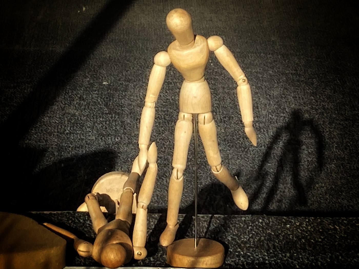 pair of wooden body models, one appearing to pull up the other
