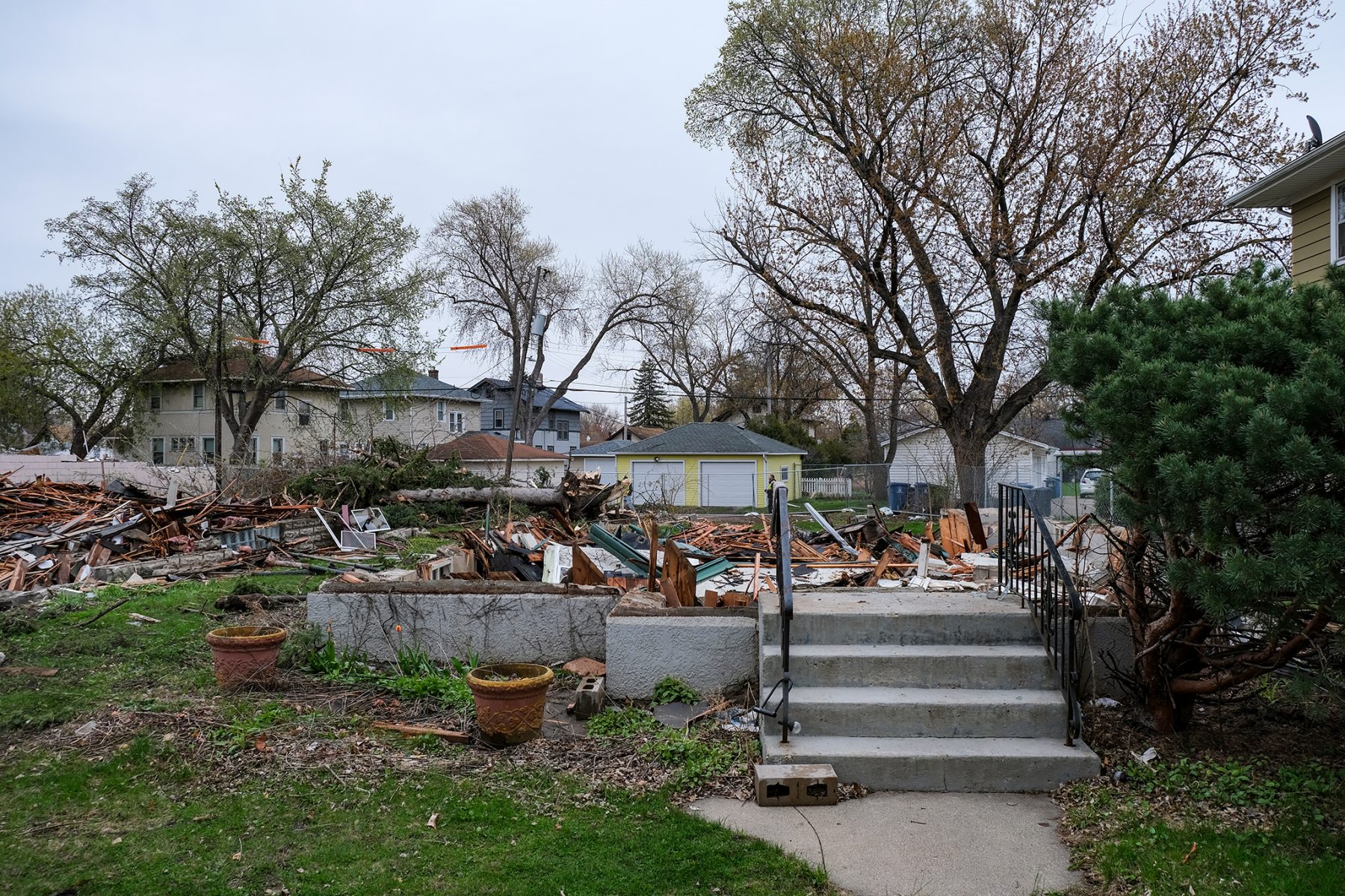 Only a flight of concrete steps remain as the demolition of two bungalows and a gas station begin.